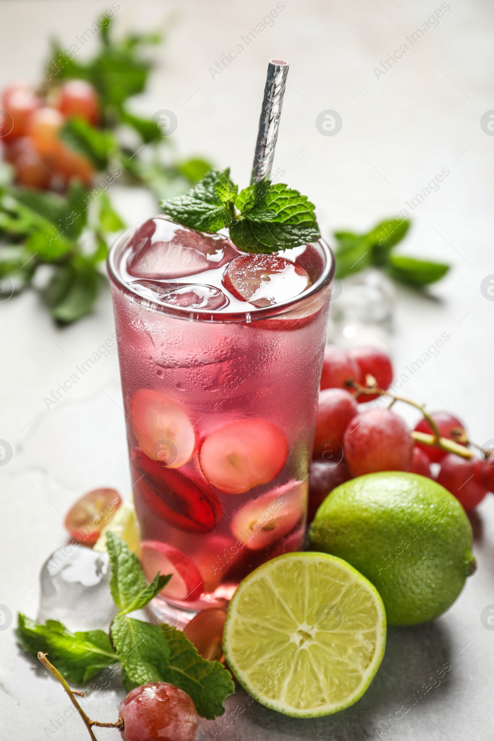 Soda water with grapes, ice, lime and mint on table. Refreshing drink Photo of Soda water with grapes, ice, lime and mint on table. Refreshing drink