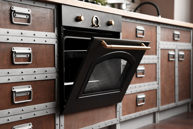 Photo of New modern oven in stylish kitchen. Cooking appliance