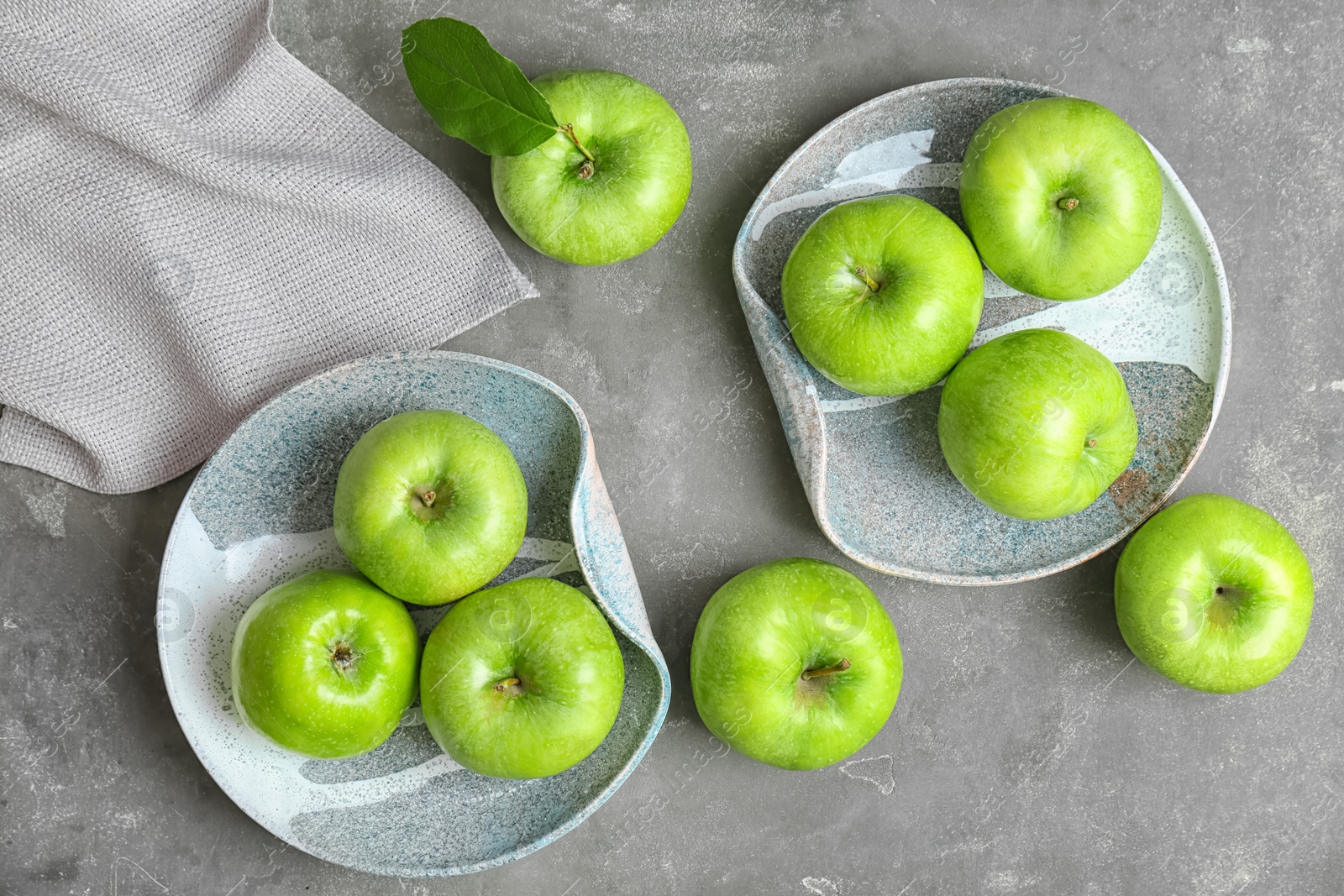 Composition with fresh green apples on grey table, top view Photo of Composition with fresh green apples on grey table, top view