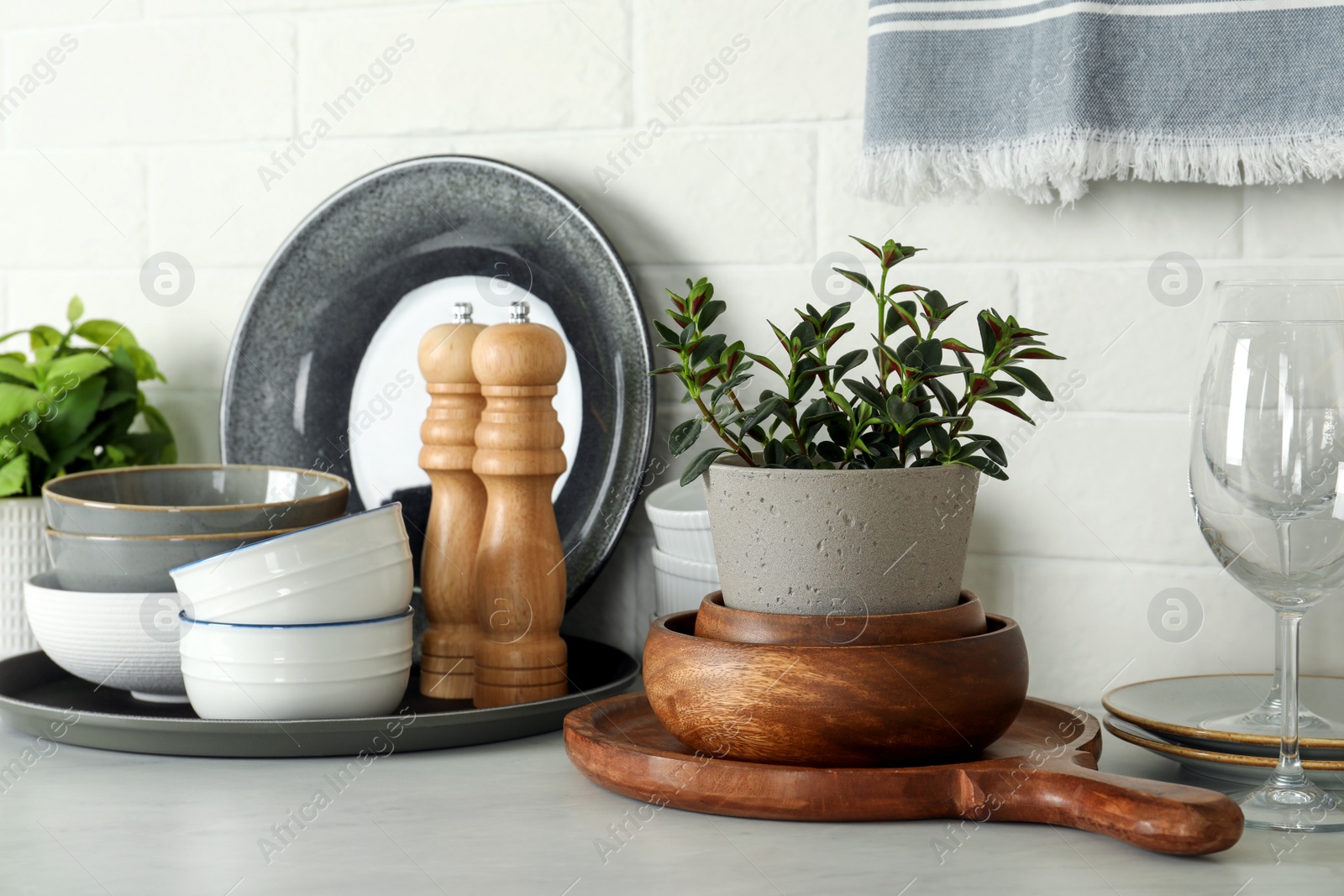 Photo of Set of clean tableware on white countertop in kitchen