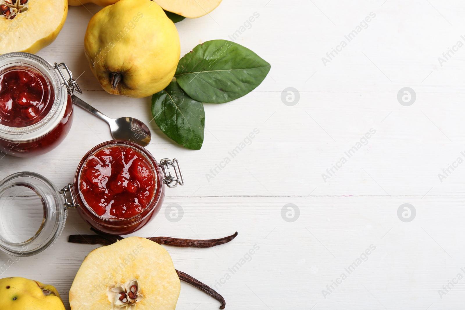 Delicious quince jam and fruits on white wooden table, flat lay. Space for text Photo of Delicious quince jam and fruits on white wooden table, flat lay. Space for text