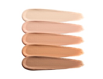Different shades of liquid skin foundation on white background, top view Image of Different shades of liquid skin foundation on white background, top view