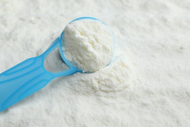 Powdered infant formula and scoop, closeup with space for text. Baby milk Photo of Powdered infant formula and scoop, closeup with space for text. Baby milk