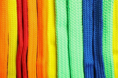 Colorful shoelaces as background, closeup. Stylish accessory Photo of Colorful shoelaces as background, closeup. Stylish accessory