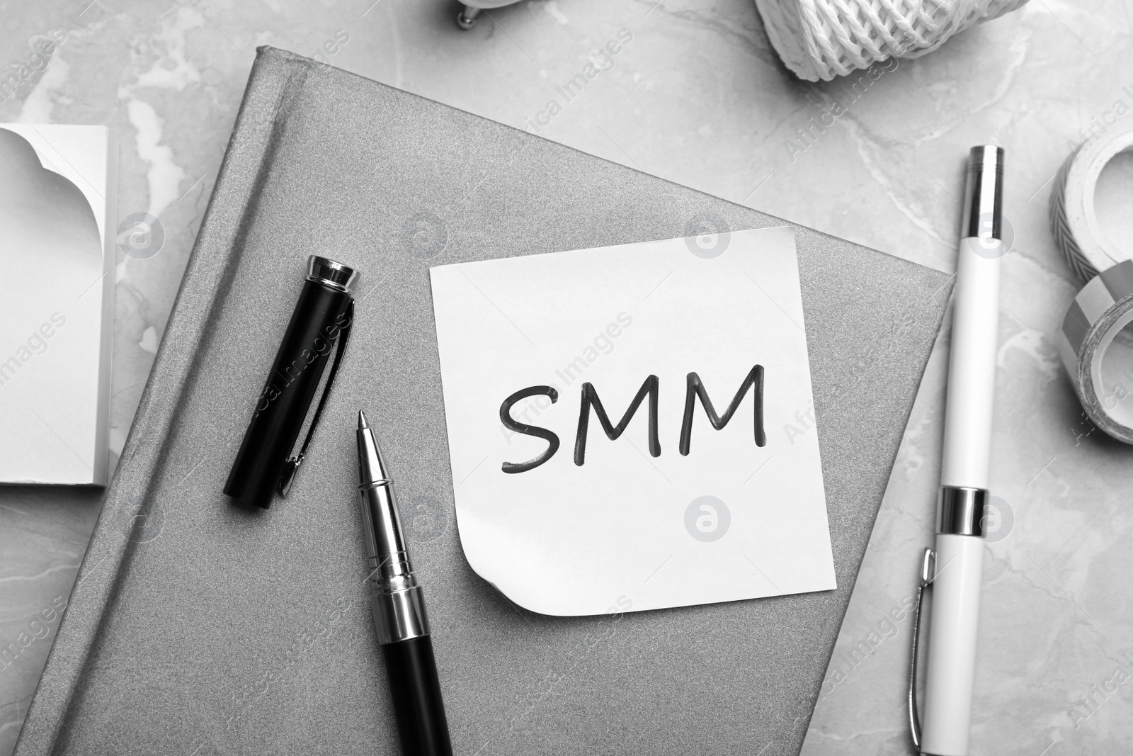 Note with abbreviation SMM and stationery on table, flat lay. Social media marketing Image of Note with abbreviation SMM and stationery on table, flat lay. Social media marketing