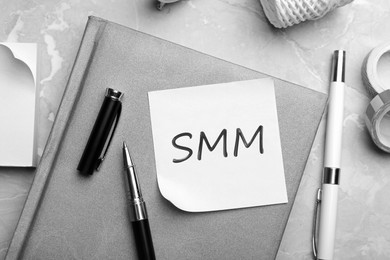 Note with abbreviation SMM and stationery on table, flat lay. Social media marketing Image of Note with abbreviation SMM and stationery on table, flat lay. Social media marketing
