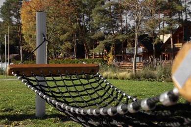 Comfortable net hammock outdoors on sunny day Photo of Comfortable net hammock outdoors on sunny day