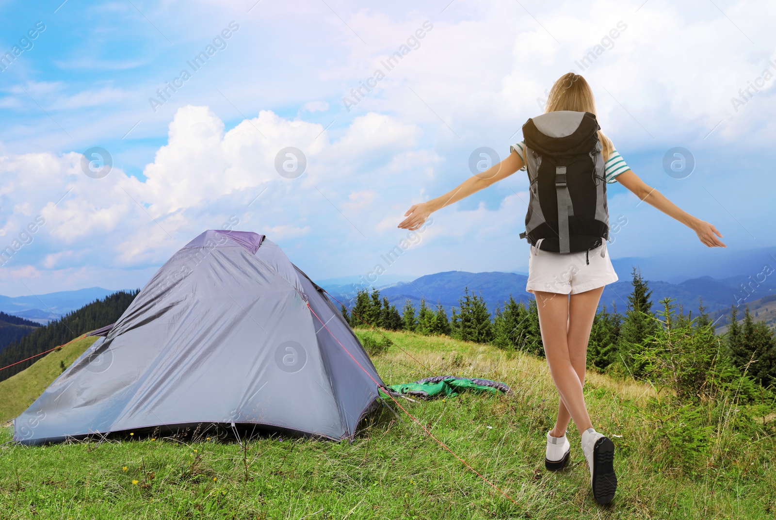Tourist with travel backpack near camp tent in mountains. Summer vacation trip Image of Tourist with travel backpack near camp tent in mountains. Summer vacation trip