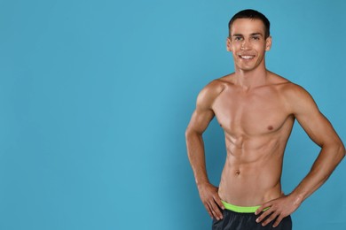Handsome shirtless man with slim body on light blue background. Space for text Photo of Handsome shirtless man with slim body on light blue background. Space for text