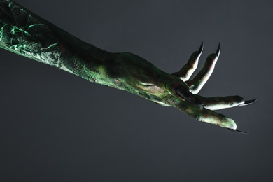 Scary monster on black background, closeup of hand. Halloween character Photo of Scary monster on black background, closeup of hand. Halloween character