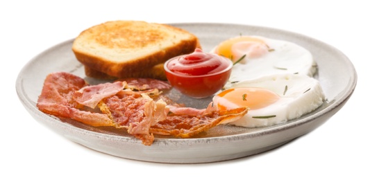 Plate with fried eggs, bacon, toasts and sauce on white background Photo of Plate with fried eggs, bacon, toasts and sauce on white background