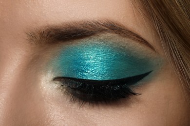 Photo of Young woman with evening makeup, closeup. Eye shadow product