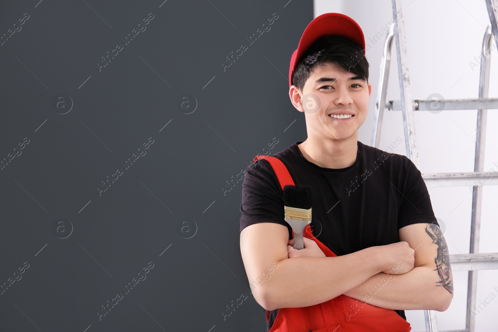 Portrait of male decorator with brush indoors Photo of Portrait of male decorator with brush indoors