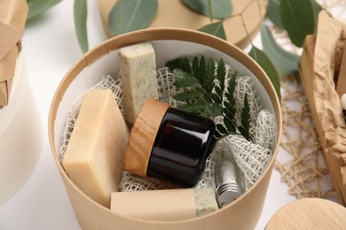 Cardboard box with eco friendly personal care products on white background, closeup Photo of Cardboard box with eco friendly personal care products on white background, closeup