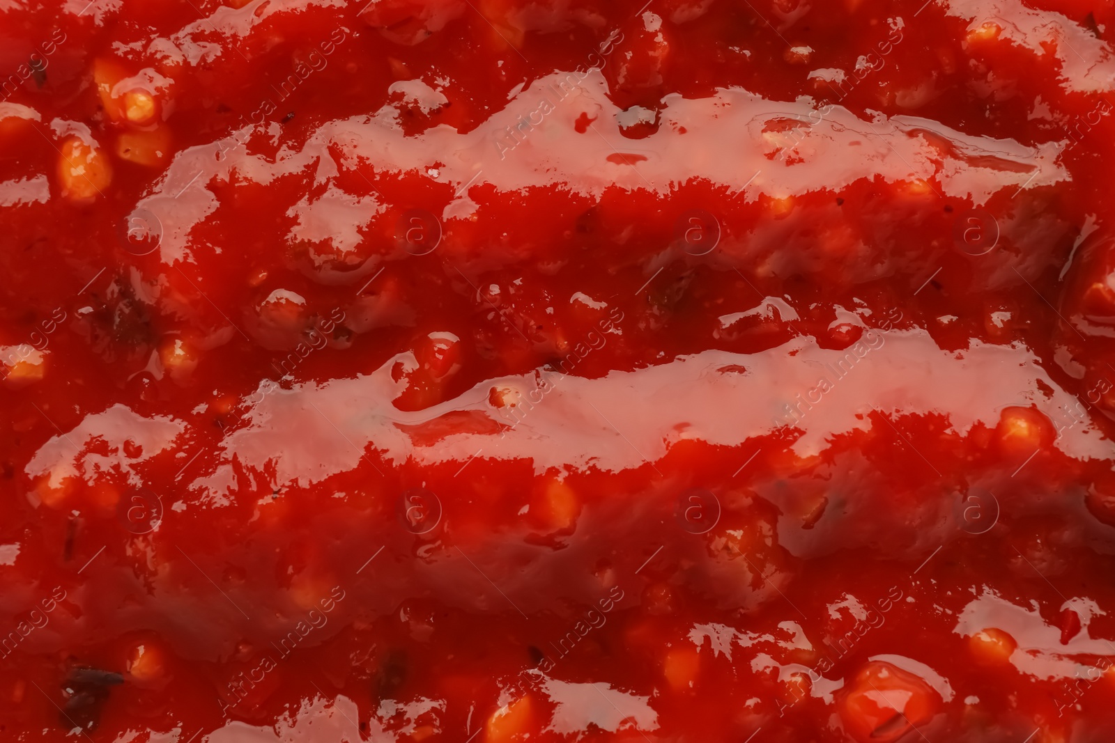 Texture of delicious adjika sauce as background, closeup Photo of Texture of delicious adjika sauce as background, closeup