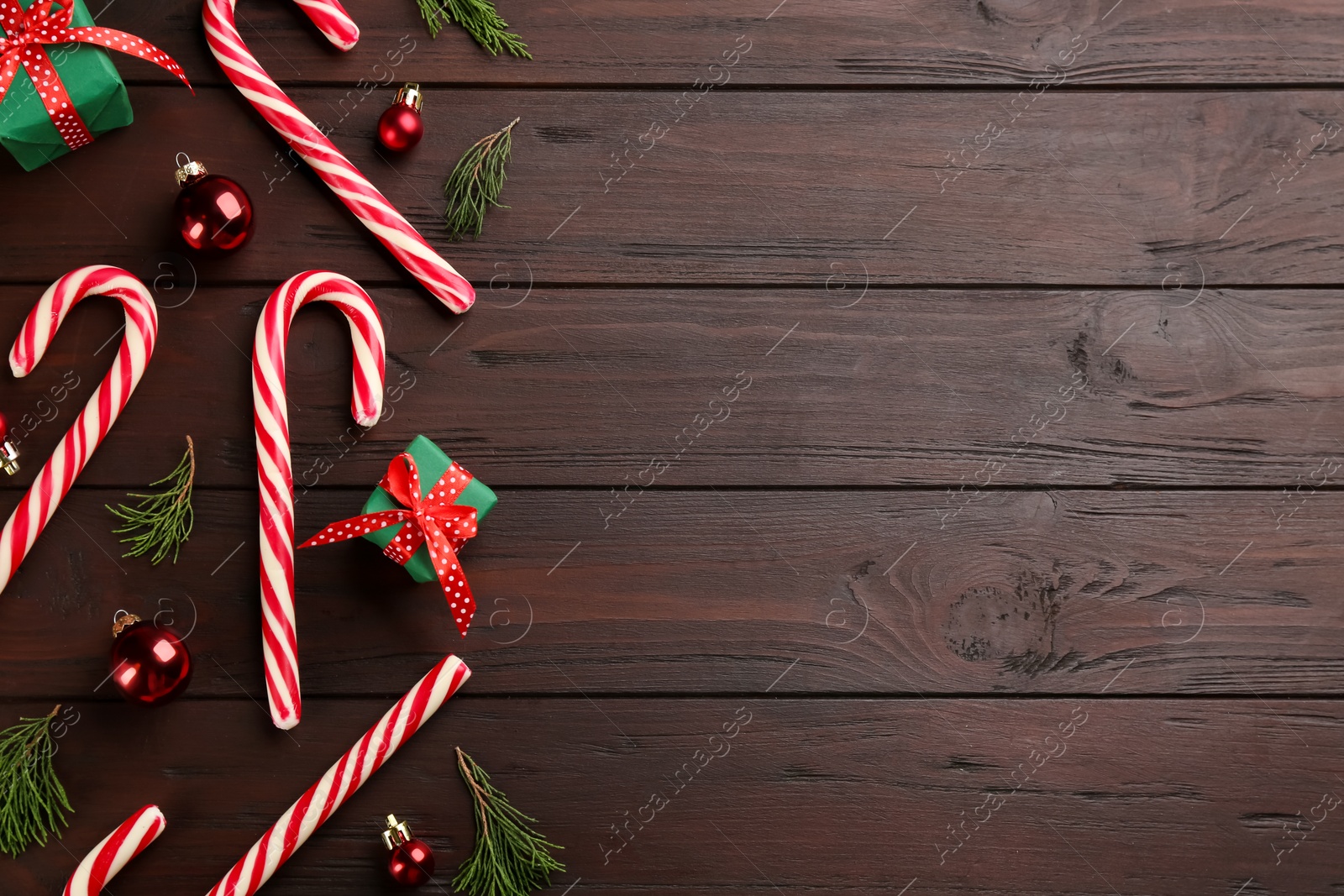 Flat lay composition with candy canes and Christmas decor on wooden table. Space for text Photo of Flat lay composition with candy canes and Christmas decor on wooden table. Space for text