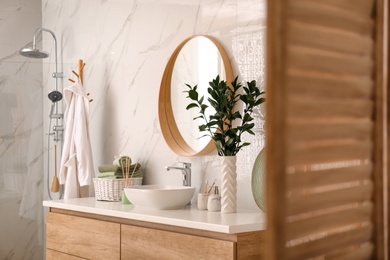 Modern bathroom interior with stylish mirror and vessel sink Photo of Modern bathroom interior with stylish mirror and vessel sink