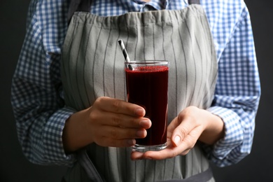 Woman with glass of fresh beet juice, closeup Photo of Woman with glass of fresh beet juice, closeup