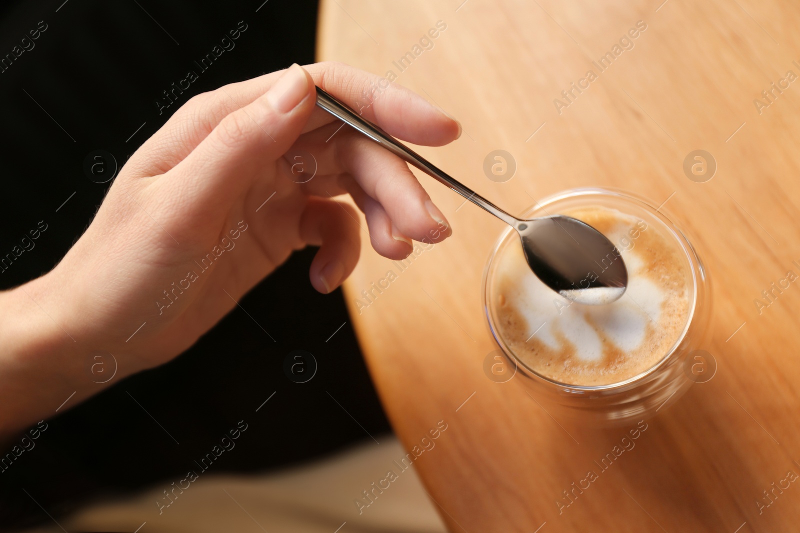 Woman with aromatic coffee at table in cafe, above view Photo of Woman with aromatic coffee at table in cafe, above view