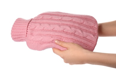 Photo of Woman holding hot water bottle with knitted cover isolated on white, closeup