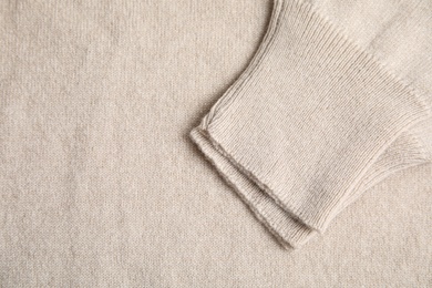 Warm cashmere sweater as background, top view Photo of Warm cashmere sweater as background, top view