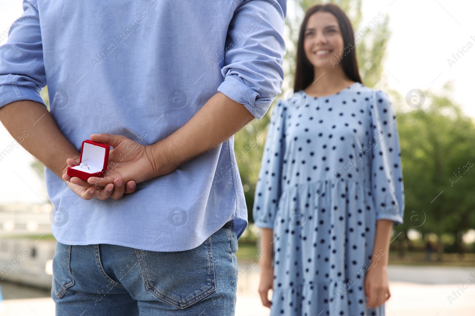 Man with engagement ring making proposal to his girlfriend outdoors, closeup Photo of Man with engagement ring making proposal to his girlfriend outdoors, closeup