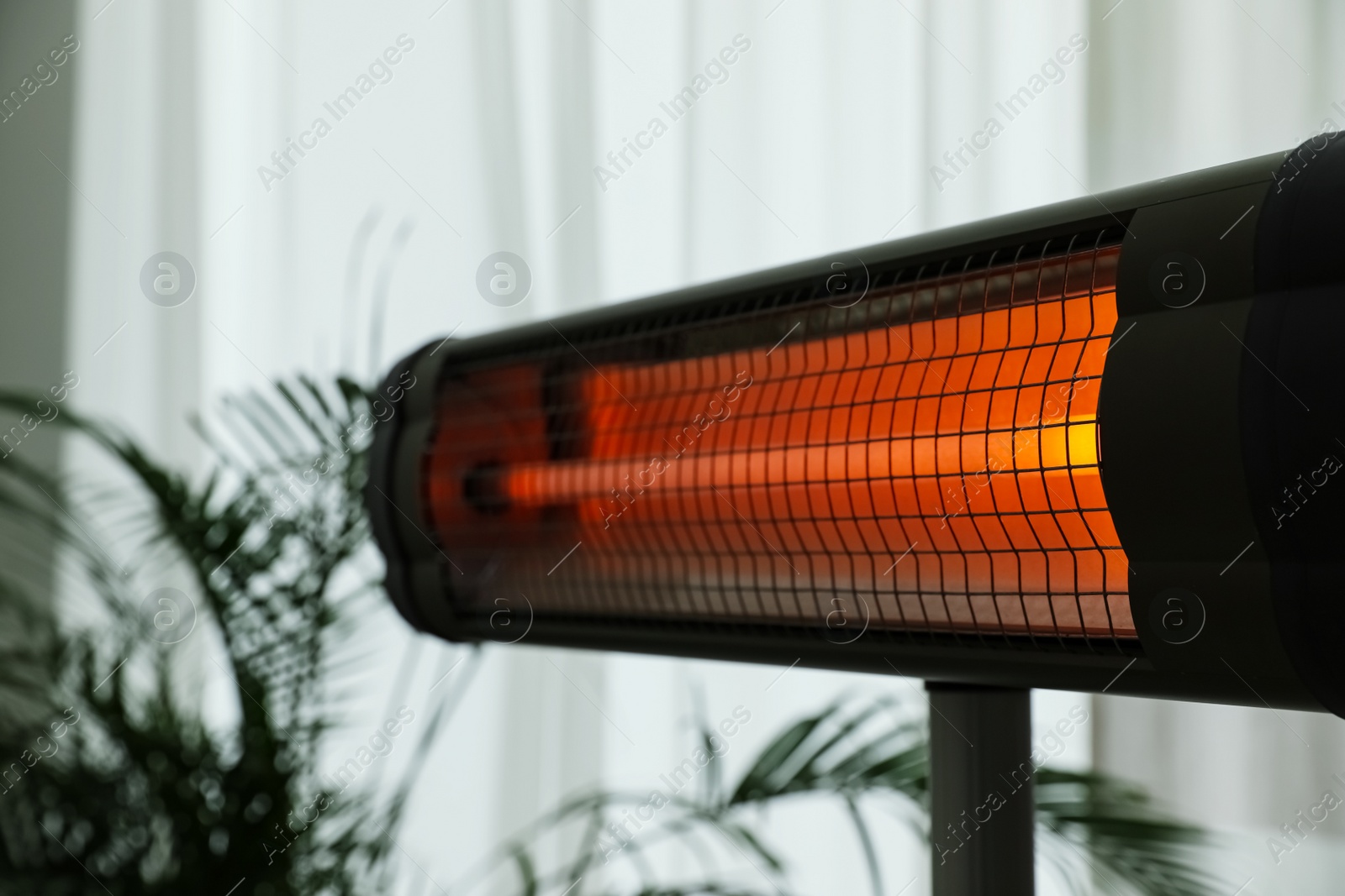 Modern electric infrared heater in room, closeup Photo of Modern electric infrared heater in room, closeup