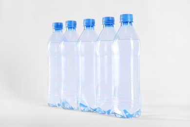 Plastic bottles with pure water on white background Photo of Plastic bottles with pure water on white background