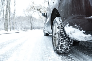 Modern car with winter tires on snowy road Photo of Modern car with winter tires on snowy road