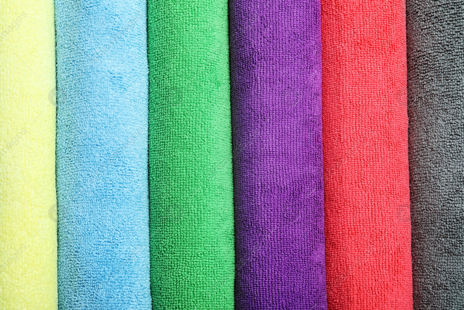 Many colorful microfiber cloths as background, top view Photo of Many colorful microfiber cloths as background, top view