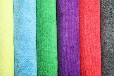 Many colorful microfiber cloths as background, top view Photo of Many colorful microfiber cloths as background, top view