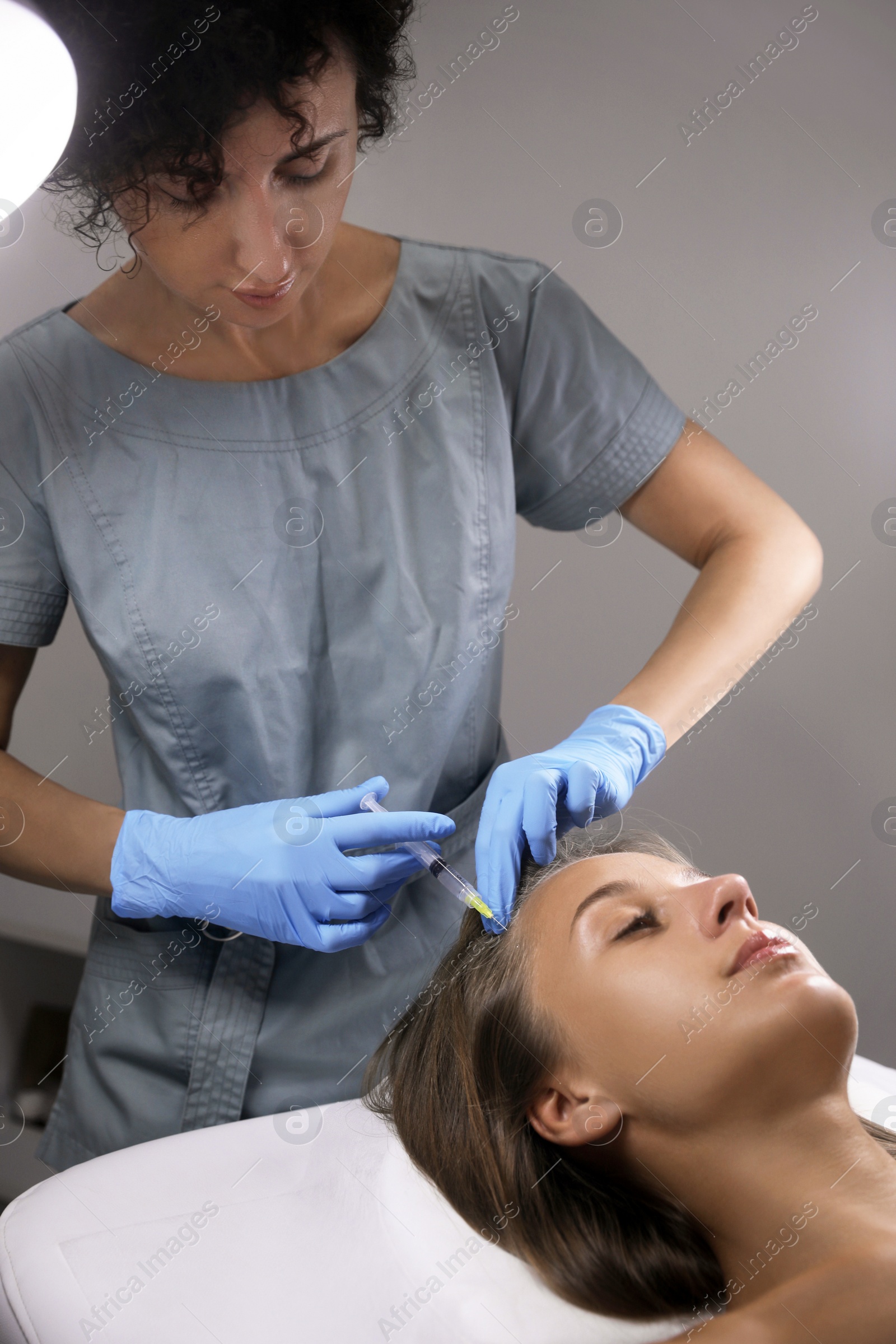 Beautiful woman getting facial injection in salon Photo of Beautiful woman getting facial injection in salon