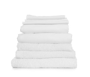 Stack of towels and bed sheets on white background Photo of Stack of towels and bed sheets on white background