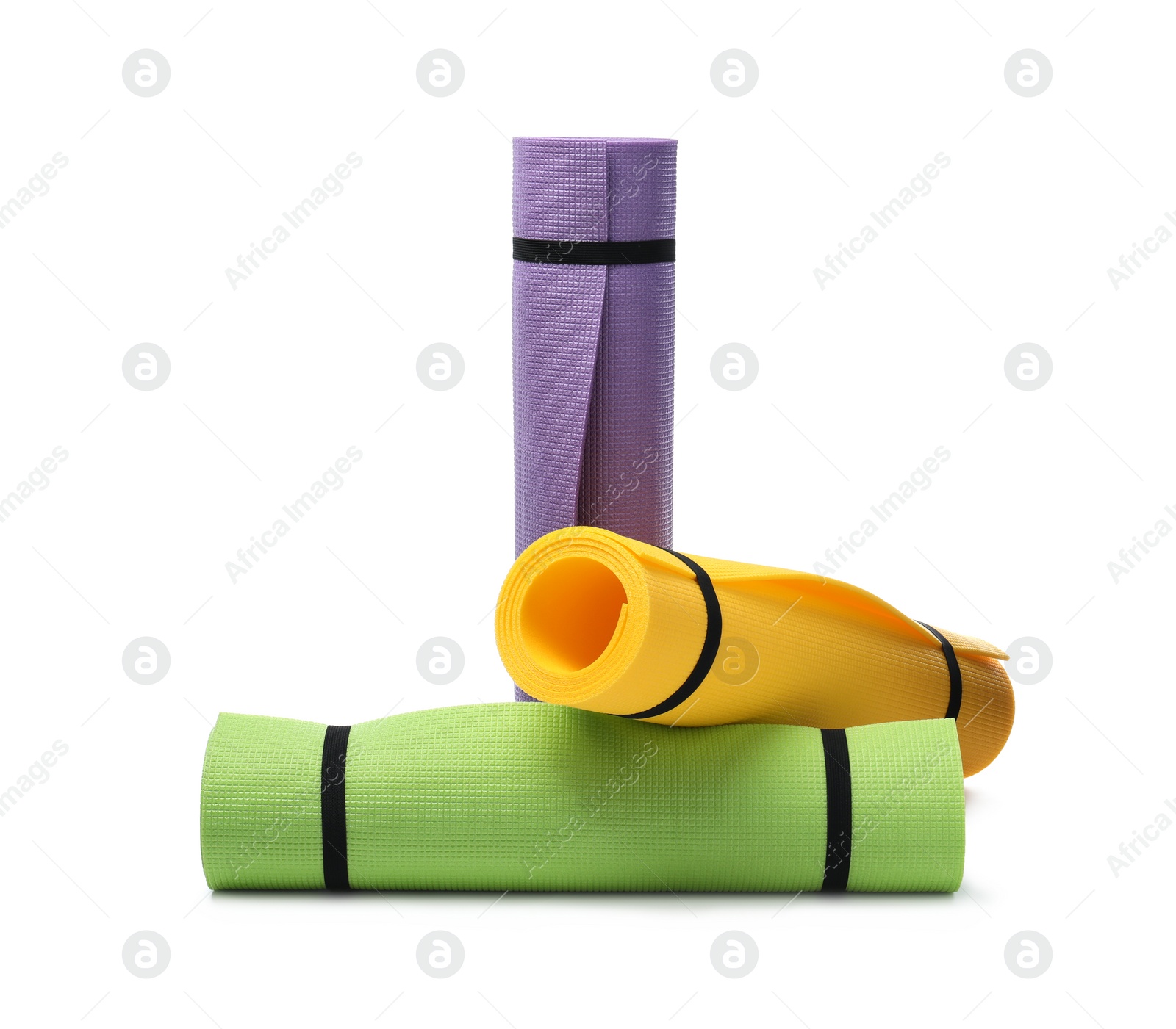Colorful rolled camping or exercise mats on white background Photo of Colorful rolled camping or exercise mats on white background