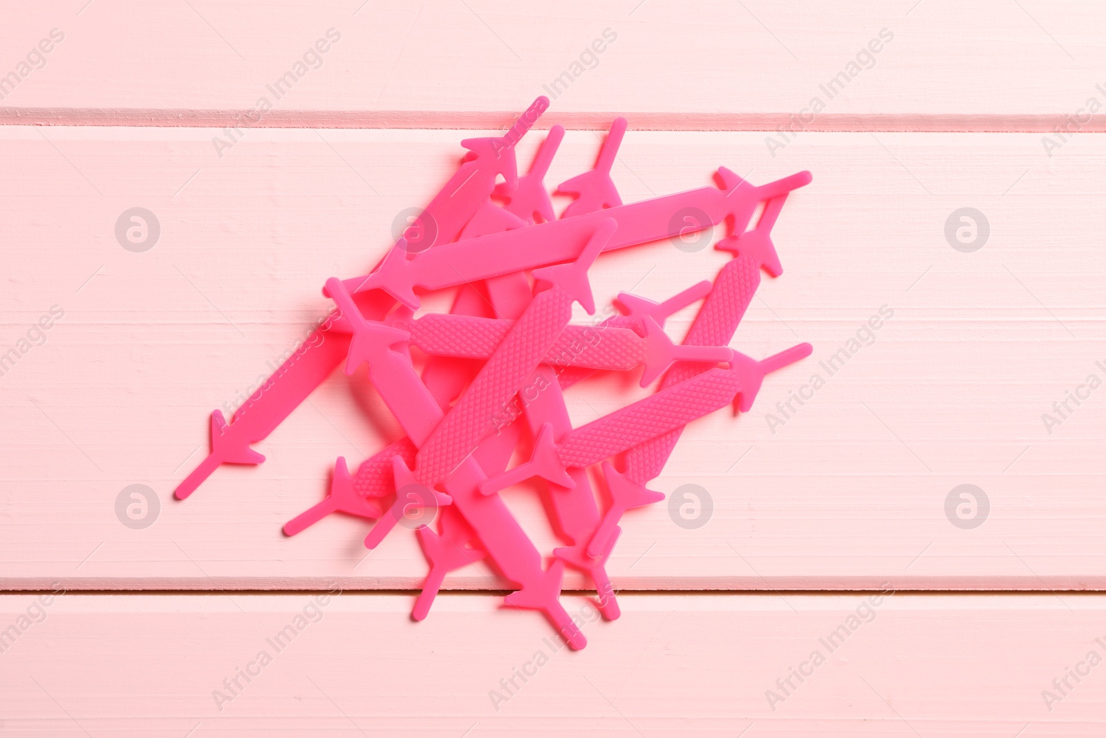 Silicone shoelaces on pink wooden background, flat lay Photo of Silicone shoelaces on pink wooden background, flat lay