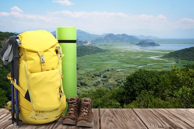 Camping equipment for tourist on wooden surface and beautiful view of mountain landscape Image of Camping equipment for tourist on wooden surface and beautiful view of mountain landscape