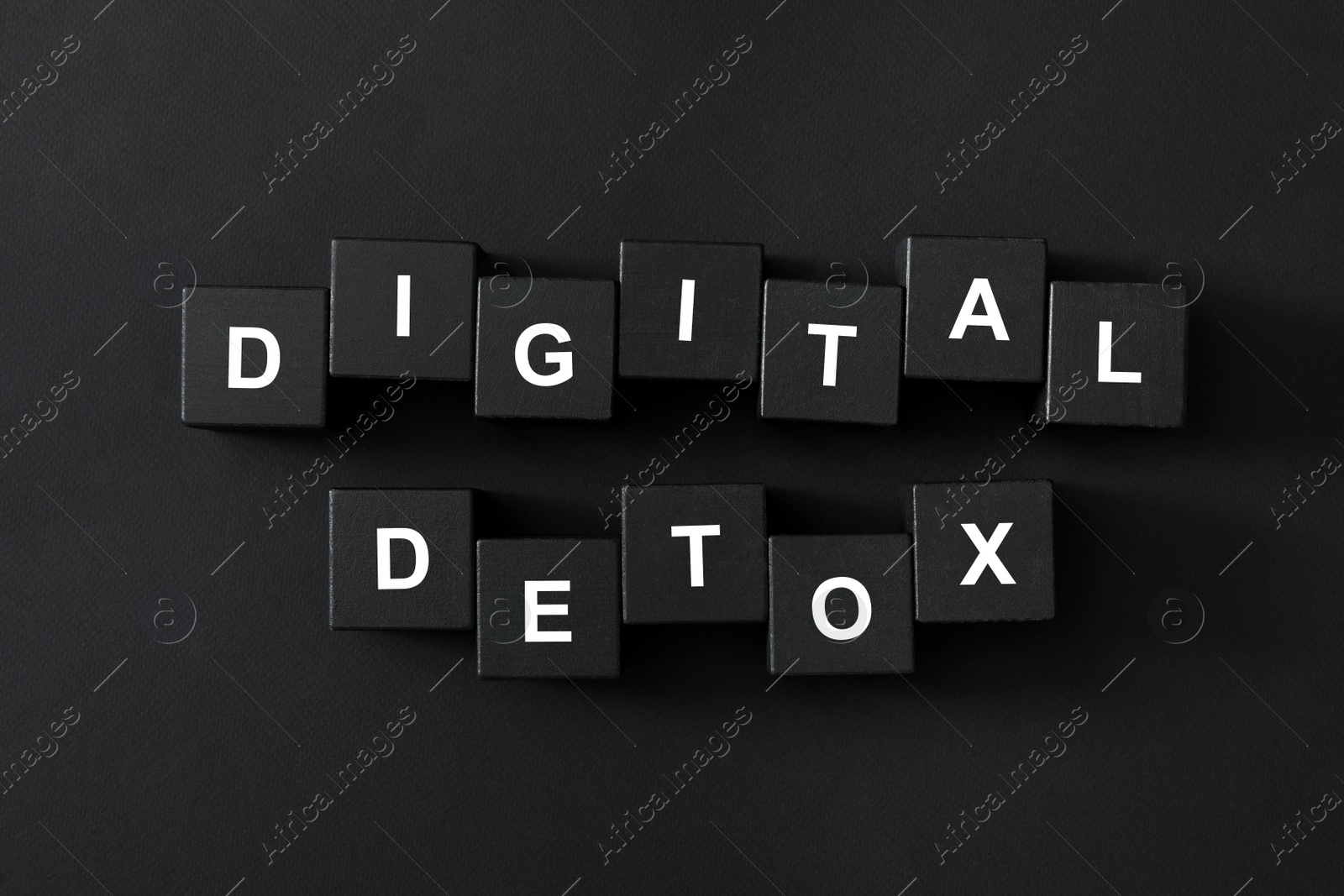Photo of Cubes with phrase DIGITAL DETOX on black background, flat lay