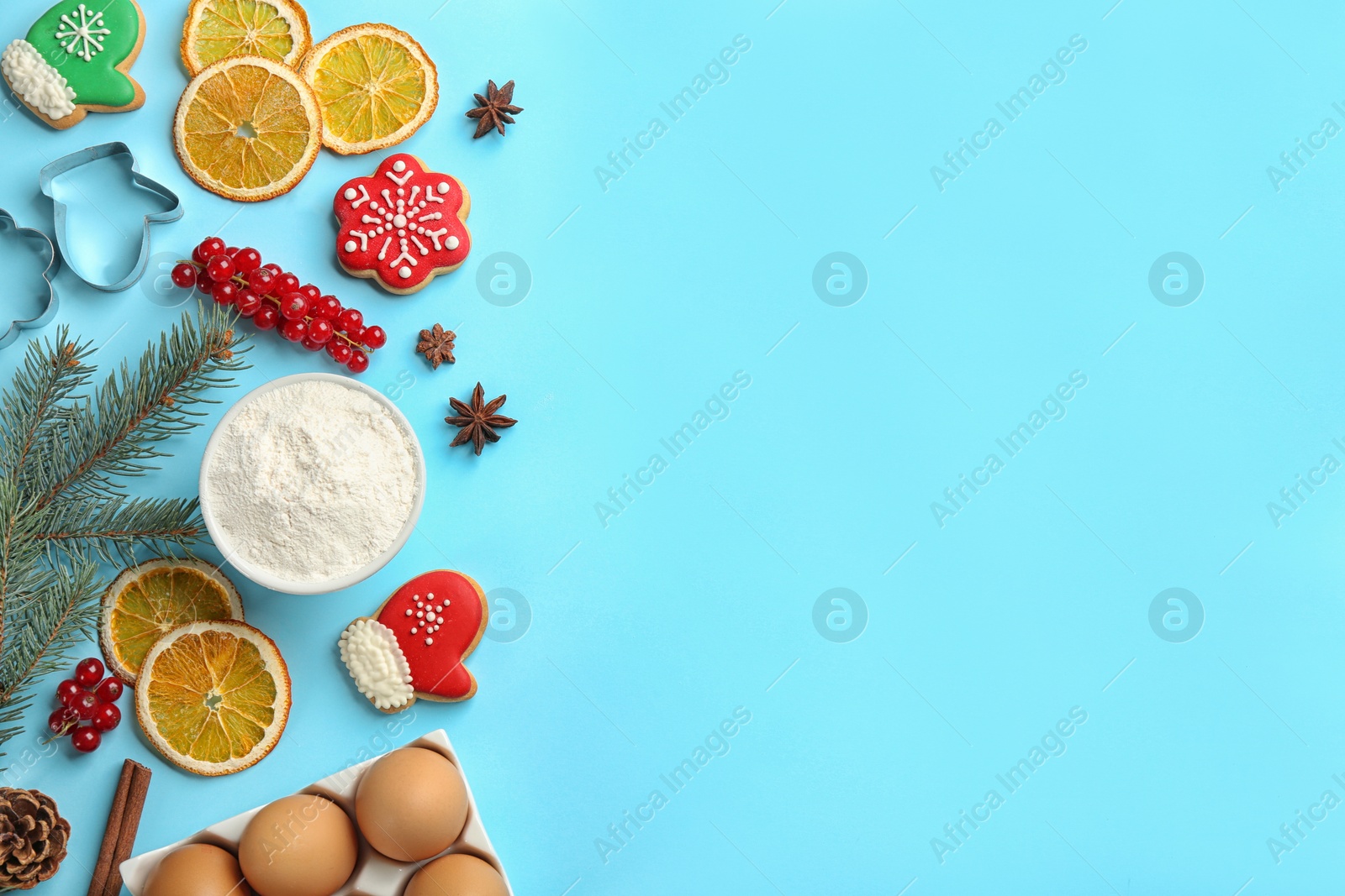 Flat lay composition with Christmas cookies and flour on light blue background. Space for text Photo of Flat lay composition with Christmas cookies and flour on light blue background. Space for text
