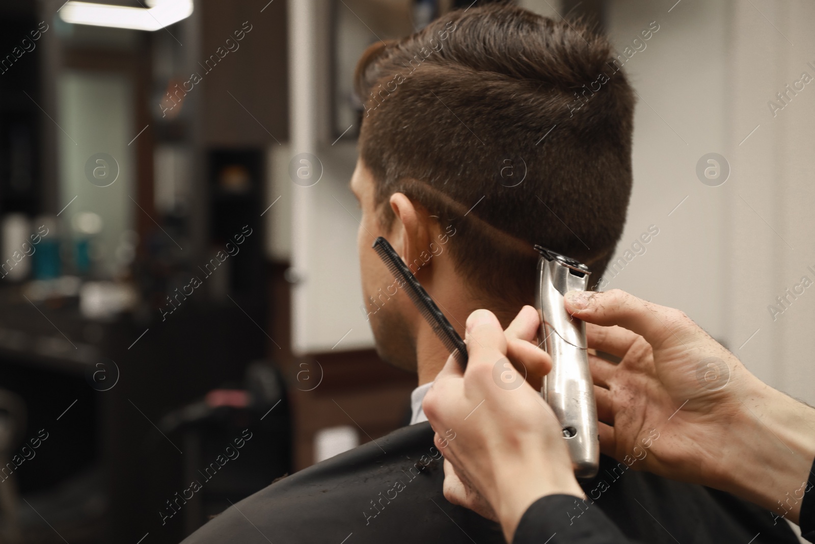 Professional hairdresser making stylish haircut in salon, closeup Photo of Professional hairdresser making stylish haircut in salon, closeup