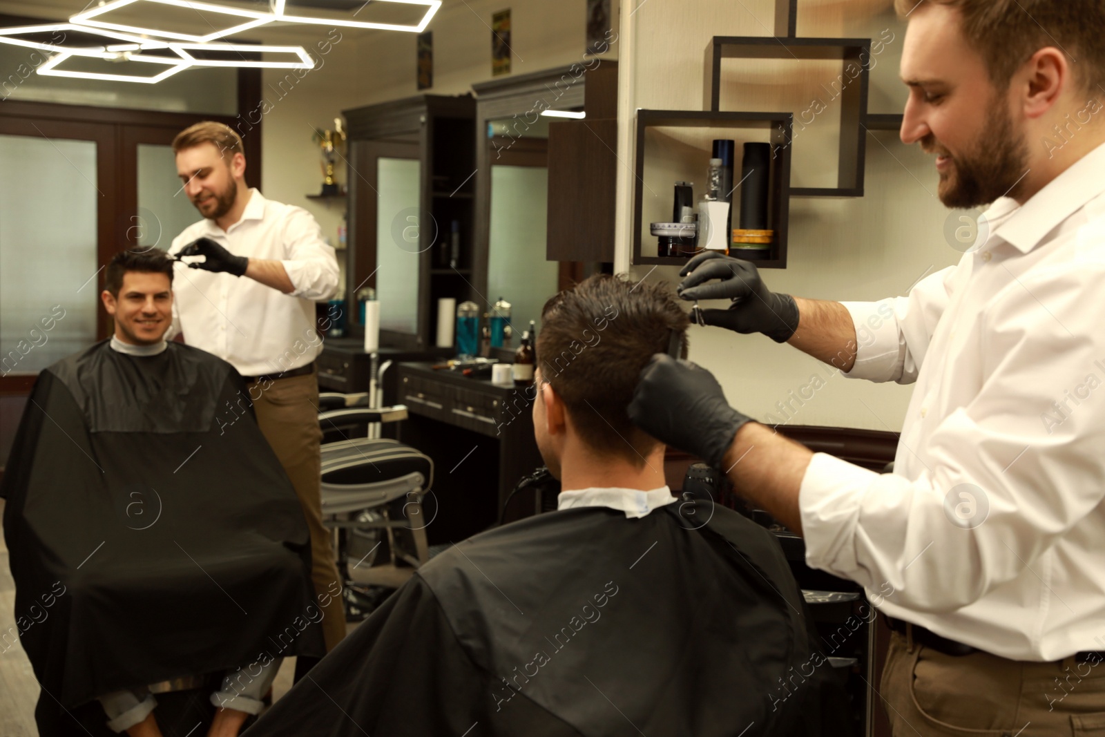 Professional hairdresser making stylish haircut in salon Photo of Professional hairdresser making stylish haircut in salon