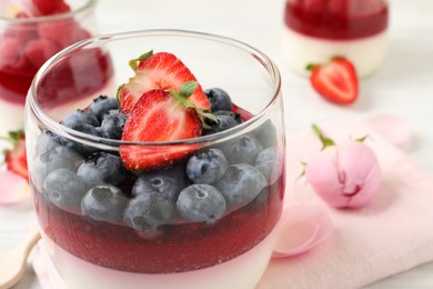 Delicious panna cotta with berries in glass dish, closeup Photo of Delicious panna cotta with berries in glass dish, closeup