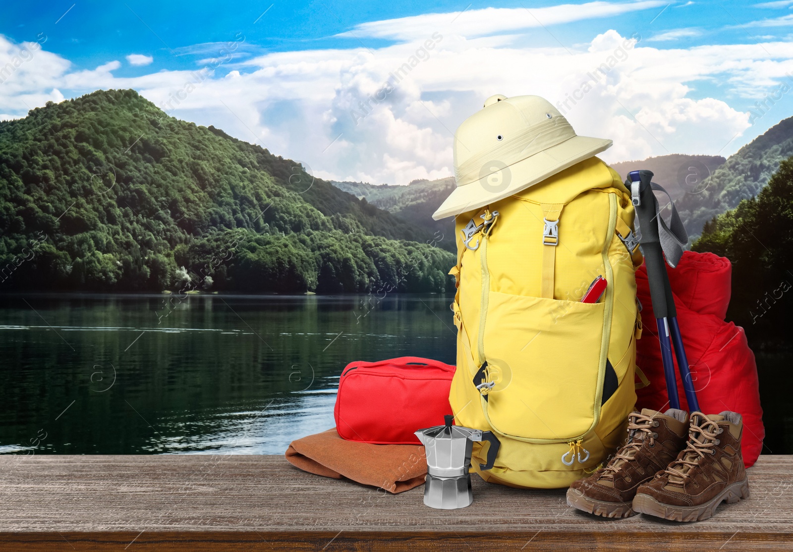 Camping equipment for tourist on wooden surface and beautiful view of mountain landscape Image of Camping equipment for tourist on wooden surface and beautiful view of mountain landscape