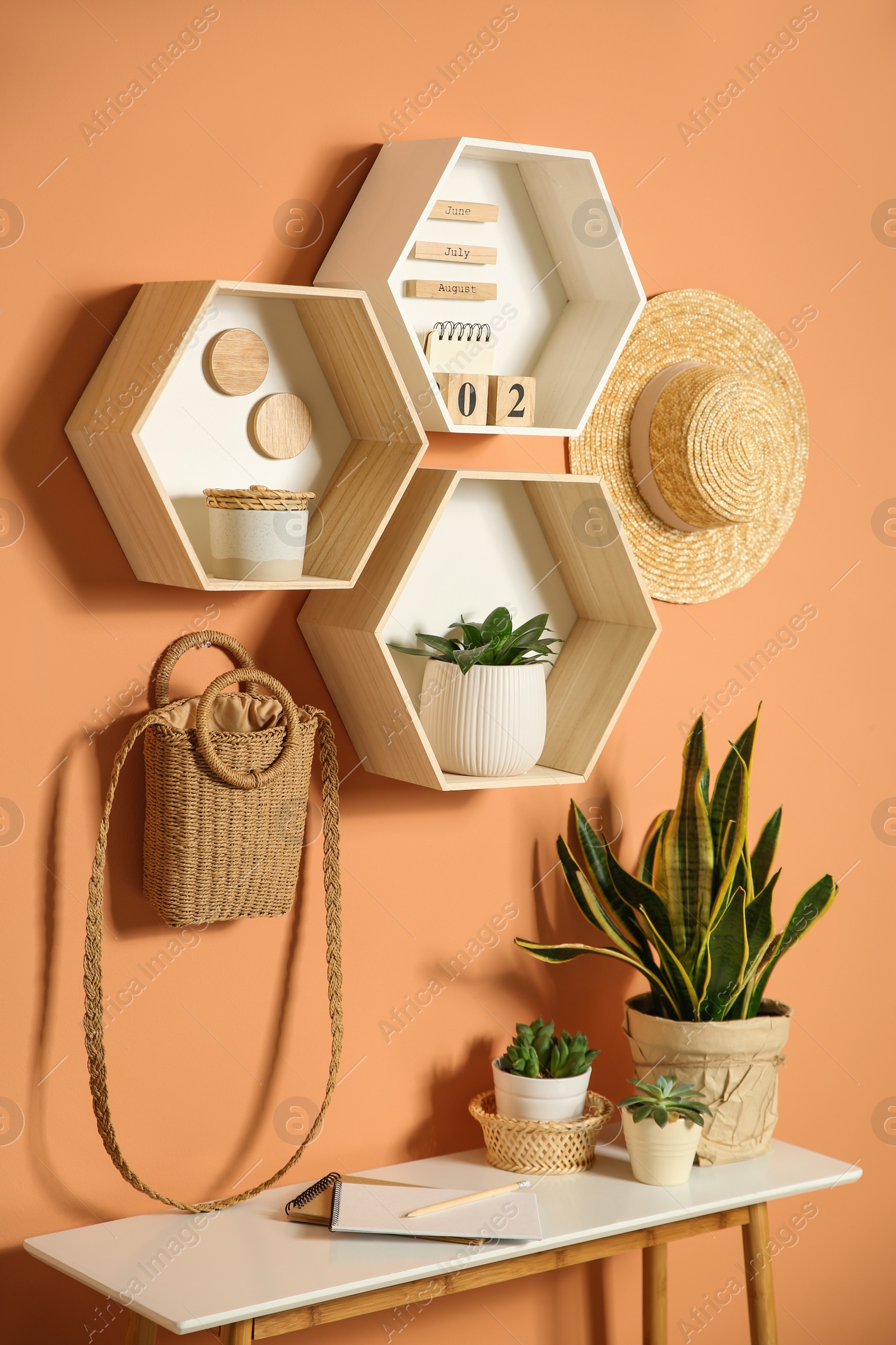 Shelves and table with decorative elements on color wall. Interior design Photo of Shelves and table with decorative elements on color wall. Interior design