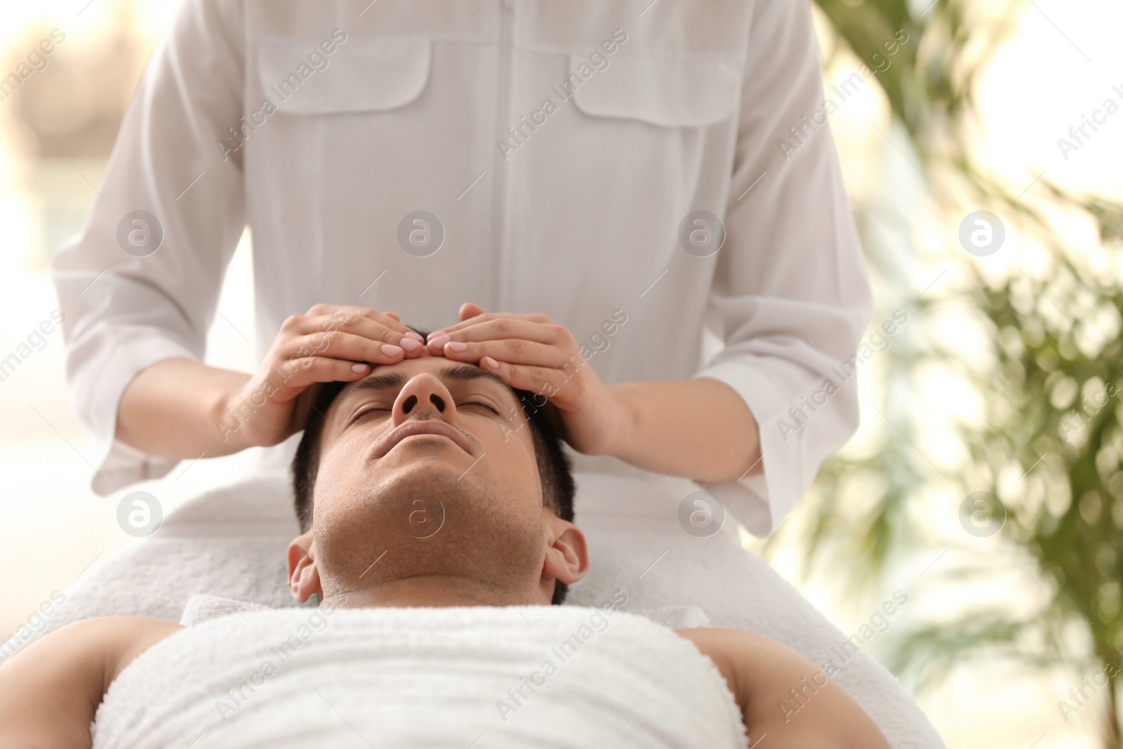 Man receiving facial massage in beauty salon Photo of Man receiving facial massage in beauty salon