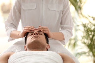 Photo of Man receiving facial massage in beauty salon