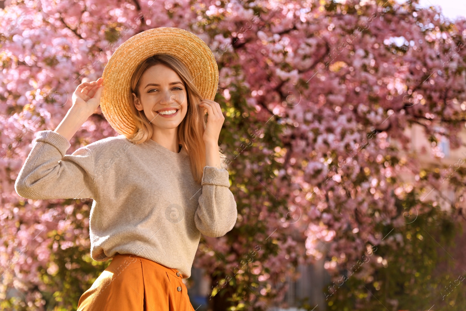 Young woman wearing stylish outfit in park on spring day. Fashionable look Photo of Young woman wearing stylish outfit in park on spring day. Fashionable look