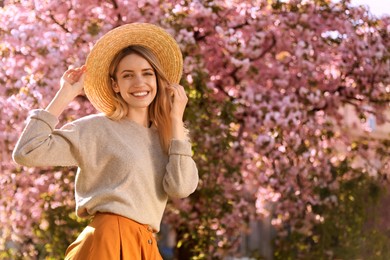 Young woman wearing stylish outfit in park on spring day. Fashionable look Photo of Young woman wearing stylish outfit in park on spring day. Fashionable look