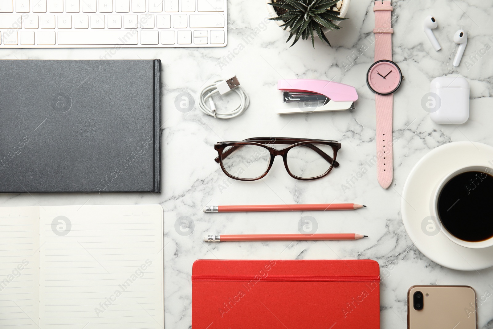 Flat lay composition with office stationery and glasses on white marble desk Photo of Flat lay composition with office stationery and glasses on white marble desk