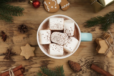 Flat lay composition with delicious marshmallow cocoa and Christmas decor on wooden table Photo of Flat lay composition with delicious marshmallow cocoa and Christmas decor on wooden table