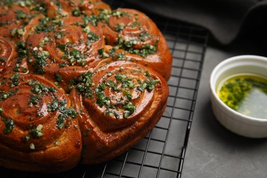 Traditional Ukrainian garlic bread with herbs (Pampushky) on grey table, closeup. Space for text Photo of Traditional Ukrainian garlic bread with herbs (Pampushky) on grey table, closeup. Space for text